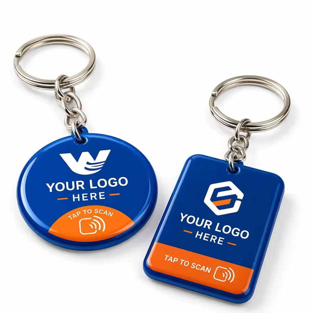 Two printed NFC keychain fobs on split rings, one round and one rectangular.